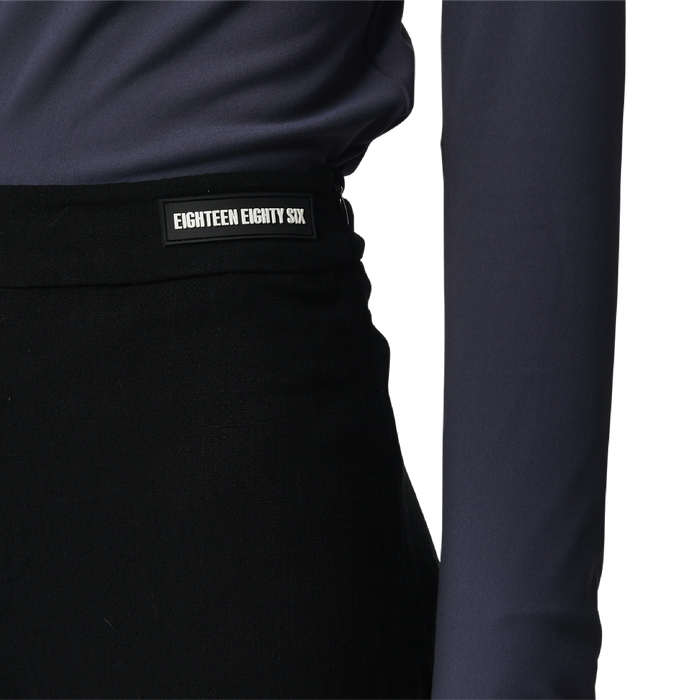 Classic fit charleston cut pants in black fabric featuring Eighteen Eighty-Six logo patch sewn at waist. High waist.