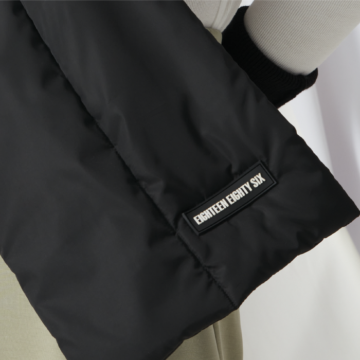 Rectangular down puffer scarf in black featuring Eighteen Eighty-Six logo patch sewn at bottom