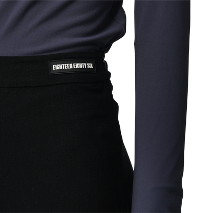 Classic fit charleston cut pants in black fabric featuring Eighteen Eighty-Six logo patch sewn at waist. High waist.