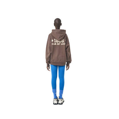 Long sleeves oversize cut hoodie in washed brown color fabric featuring 1886 print at back. 1886 logo embroidered at kangaroo pocket. A button on the hood. Rib knit at cuffs and hem