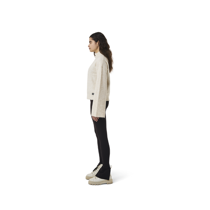 Long sleeves highneck cut wool sweater in beige color fabric featuring 1886 logo embroidered at bottom front. Loose at cuffs and hem.