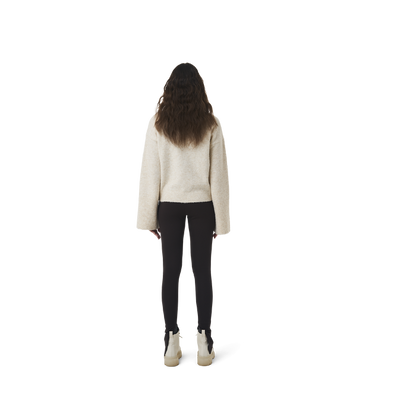 Long sleeves highneck cut wool sweater in beige color fabric featuring 1886 logo embroidered at bottom front. Loose at cuffs and hem.